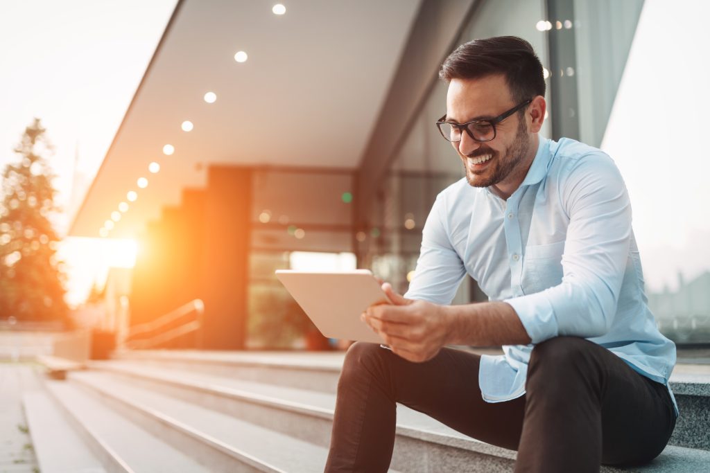 Portrait,Of,Businessman,In,Glasses,Holding,Tablet